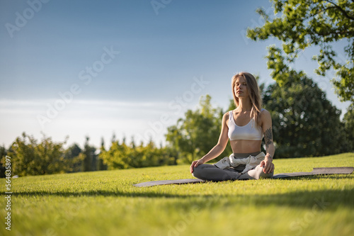 Girl practice yoga meditation outdoor in park