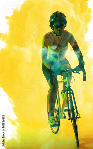 African american female athlete wearing eyeglasses and helmet riding bike on smoky background