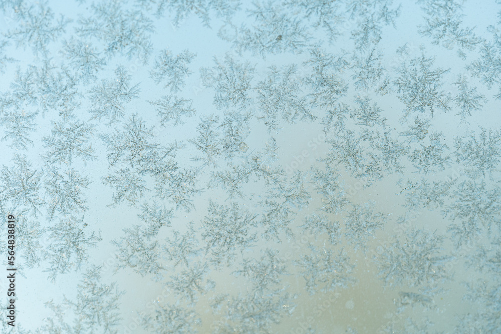 Snow crystals glued to windows in the cold winter Snow crystals glued to windows in the cold winter