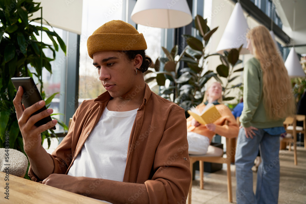 Man using smartphone in coffee shop Man using smartphone in coffee shop