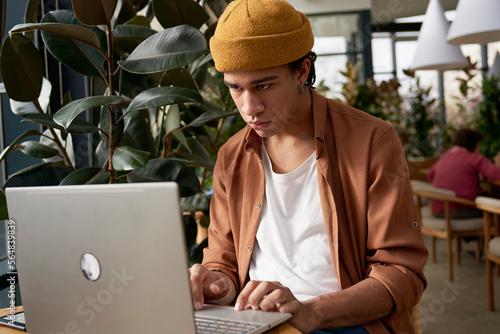 Smiling man watching video on netbook photo