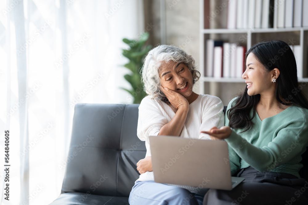 Young woman with mother using laptop at home, happy family time.. Young woman with mother using laptop at home, happy family time..