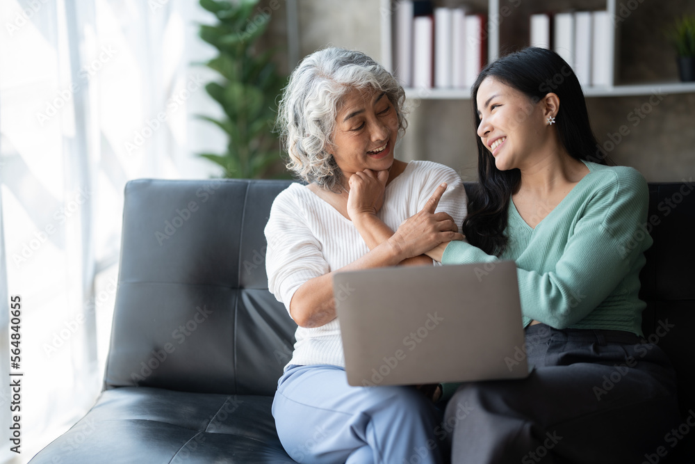 Young woman with mother using laptop at home, happy family time.. Young woman with mother using laptop at home, happy family time..