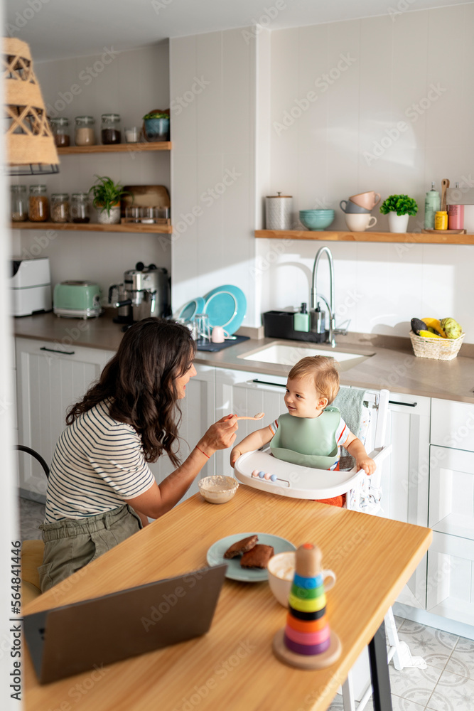 Young mother feeding her baby