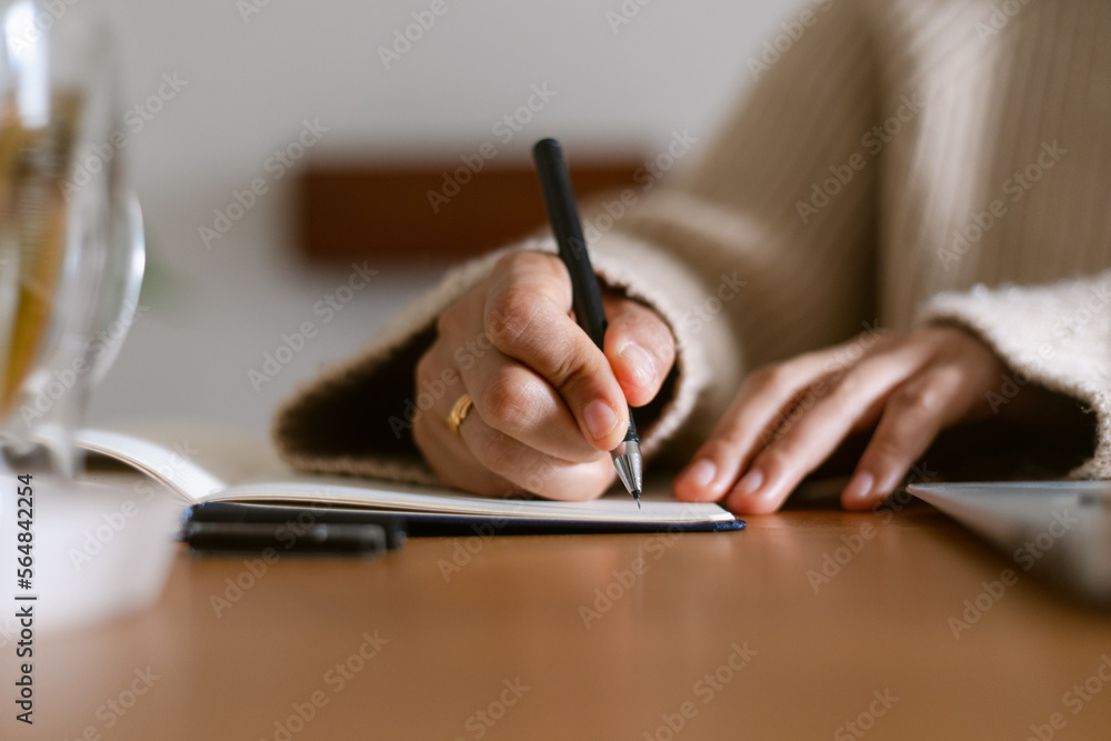 Female writing on notebook closeup Female writing on notebook closeup