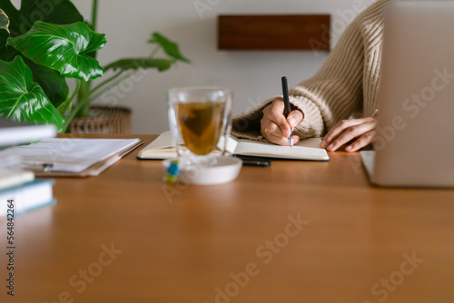 Cropped woman working at tidy office desk