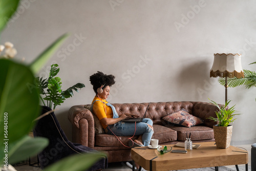 Woman Using Laptop On The Sofa