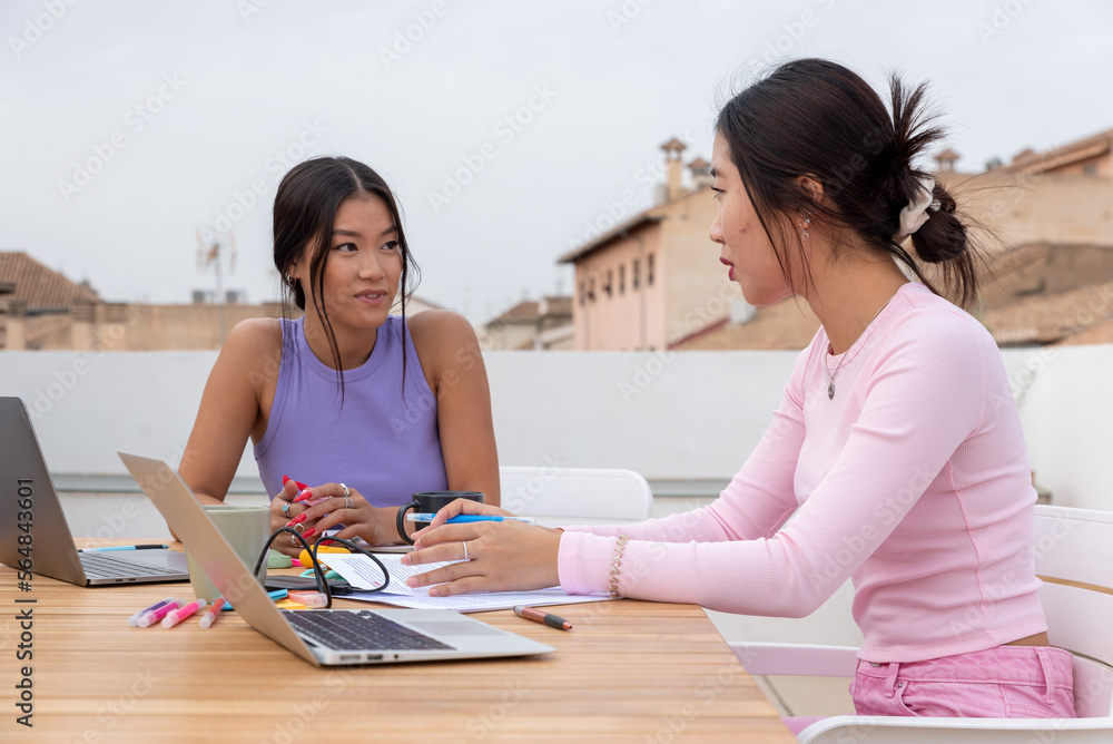 Asian classmates studying together