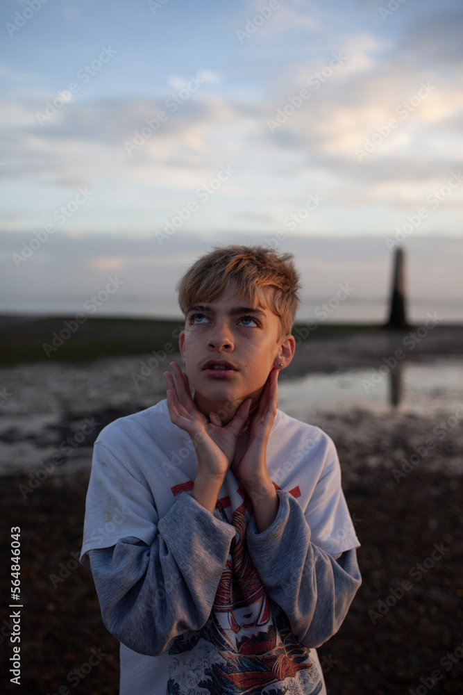 Portrait of teen boy on beach at sunset Portrait of teen boy on beach at sunset