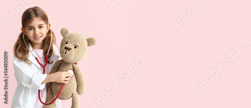 Cute little doctor with toy...