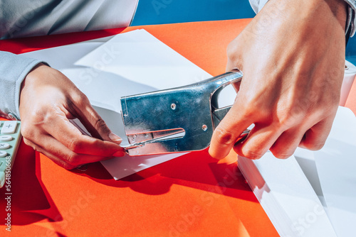 administration worker using staple gun