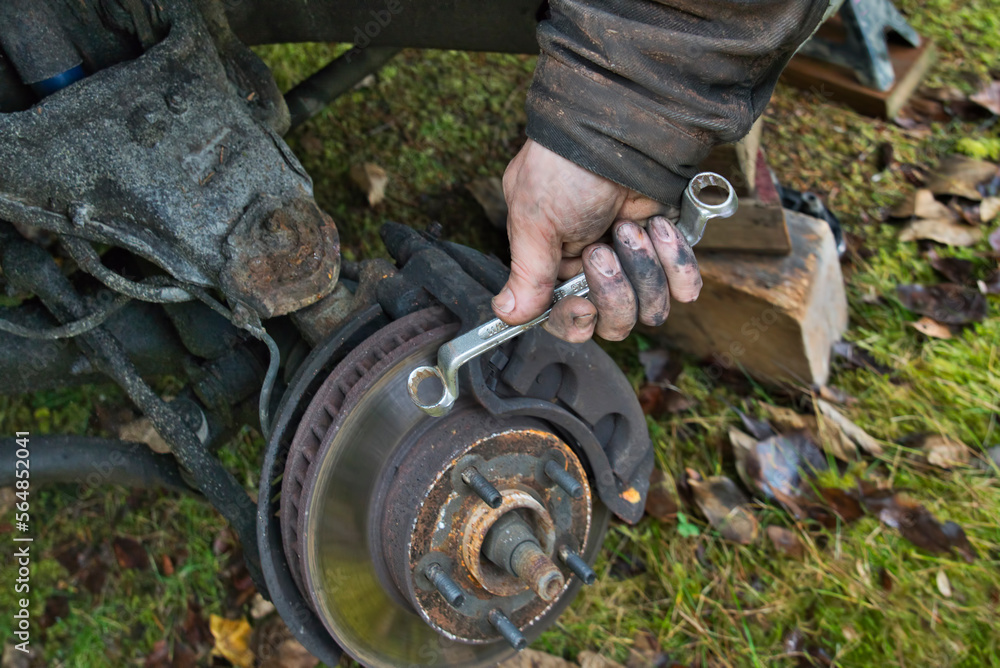 Home auto mechanic fixing brake pads on a car. Home auto mechanic fixing brake pads on a car.