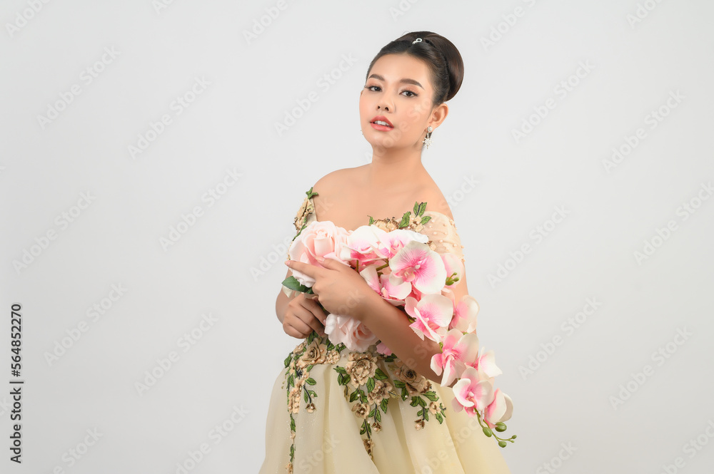 Young asian beautiful bride with orchid bouquet on white background Young asian beautiful bride with orchid bouquet on white background