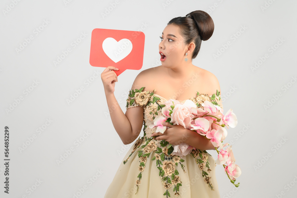 Asian beautiful bride smiling and posing with heart sign on white background Asian beautiful bride smiling and posing with heart sign on white background