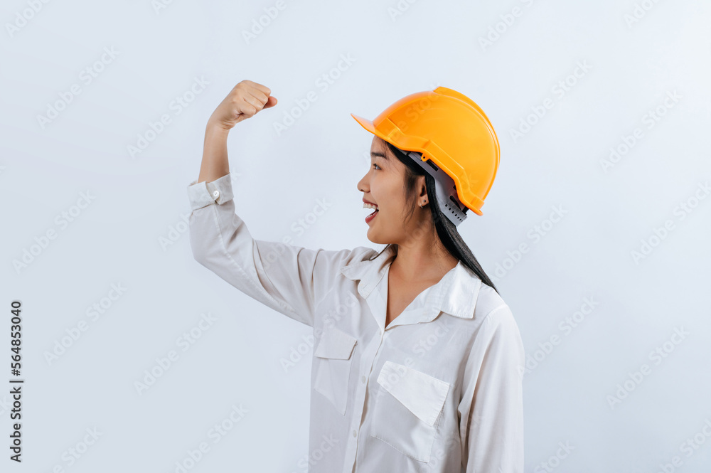 Young female engineer wearing Yellow helmet and healthy sign posture Young female engineer wearing Yellow helmet and healthy sign posture