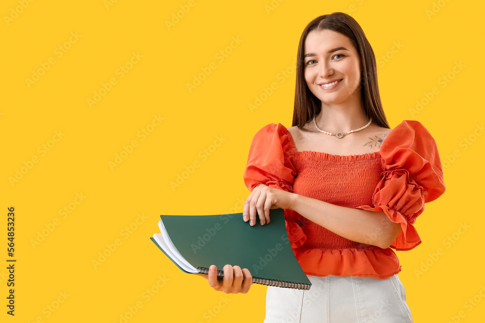 Young woman with folder on yellow background Young woman with folder on yellow background