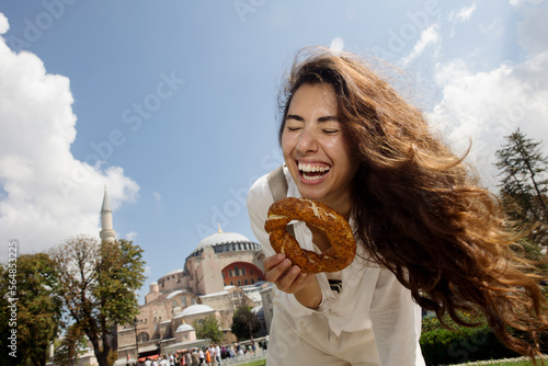 Woman laughing and holding a donut photo