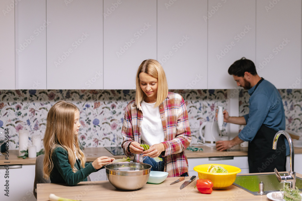 Family prepare kitchen fresh salad meal Christmas together Family prepare kitchen fresh salad meal Christmas together