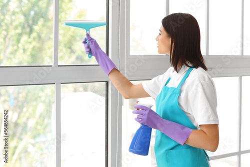 Female janitor cleaning win...