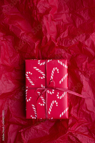 Christmas present wrapped with candy cane giftwrap