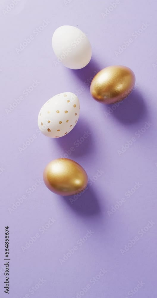 Vertical video of white and gold easter eggs on pink background with copy space Vertical video of white and gold easter eggs on pink background with copy space