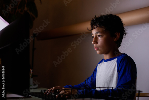 teen boy in front computer