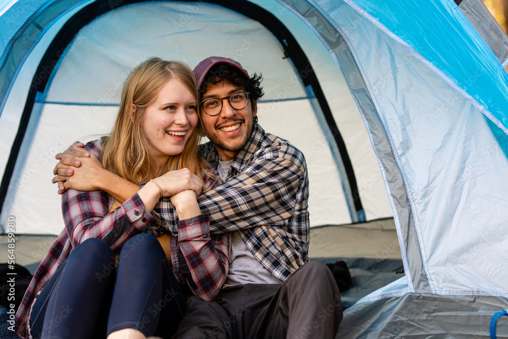 Happy Couple Embrace And Smile At Camera From Their Blue Tent Happy Couple Embrace And Smile At Camera From Their Blue Tent