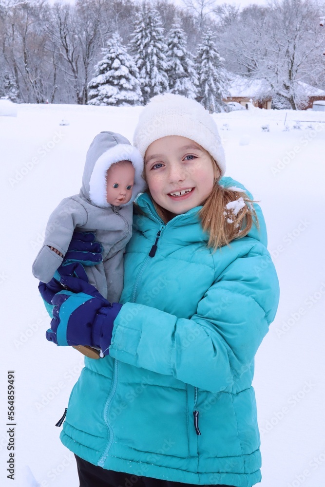 Fototapeta premium child and doll in winter
