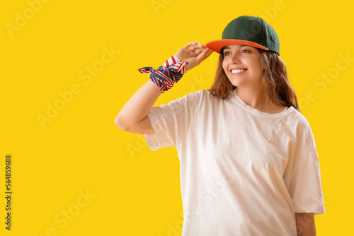 Female hip-hop dancer on yellow background