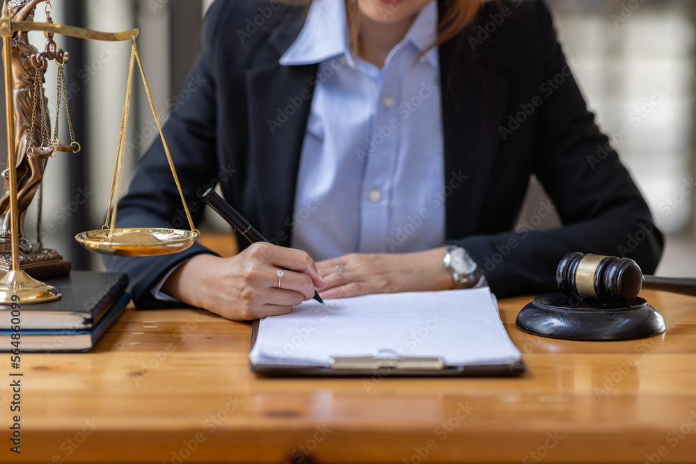 Business Asian woman in suit and Lawyer working on a documents at workplace office. Judge gavel with Justice lawyers, Legal law, advice and justice concept Business Asian woman in suit and Lawyer working on a documents at workplace office. Judge gavel with Justice lawyers, Legal law, advice and justice concept