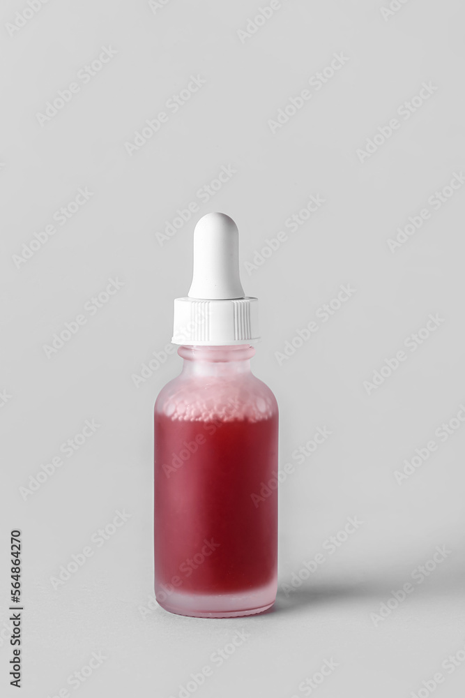 Glass bottle of serum on light background Glass bottle of serum on light background