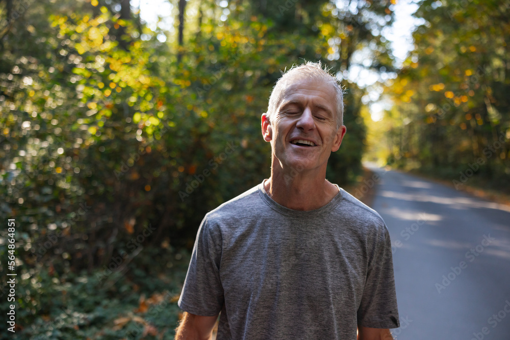 Tired man on road after intense run in autumn nature. Tired man on road after intense run in autumn nature.