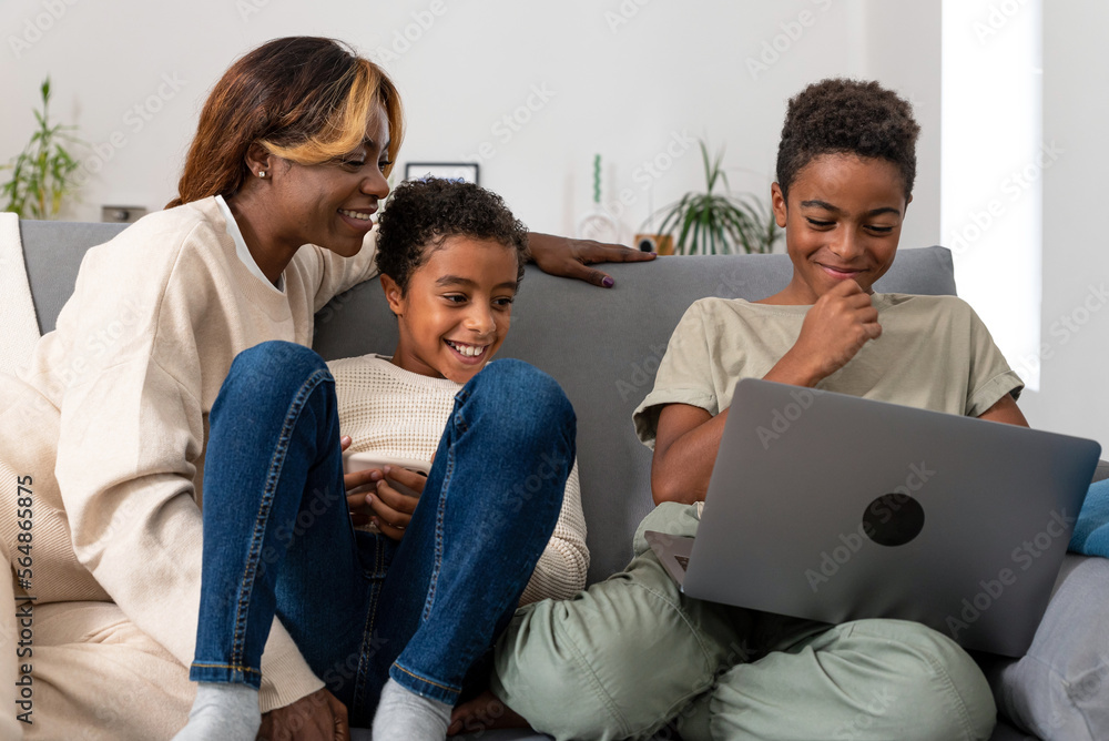 Happy mother and sons watching video together Happy mother and sons watching video together