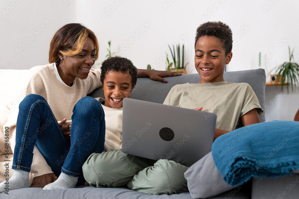 Happy mother and sons watching video together Happy mother and sons watching video together