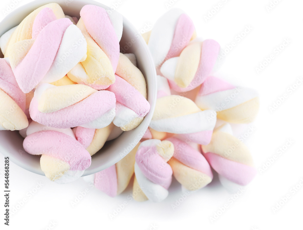 Bowl and heap of tasty twisted marshmallows isolated on white background