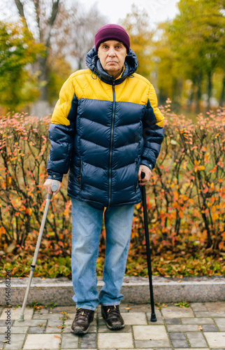 Disabled Senior man standing outdoors .
