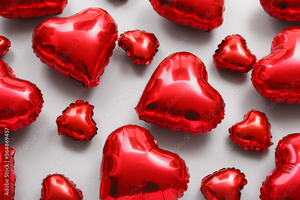 Many red heart shaped balloons on light background. Valentine's Day celebration