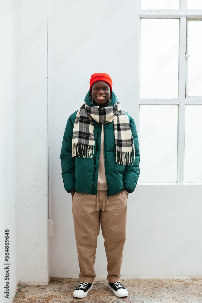 © BONNINSTUDIO/Stocksy - Man in warm clothes standing near window © BONNINSTUDIO/Stocksy - Man in warm clothes standing near window