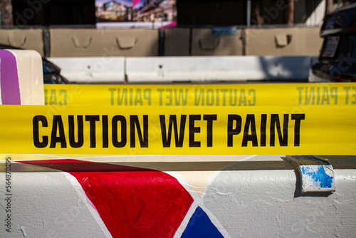 Caution Wet Paint Sign in yellow tape