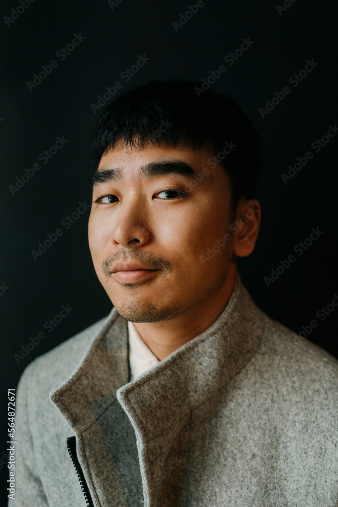 Portrait of elegant man over black background smiling at camera Portrait of elegant man over black background smiling at camera