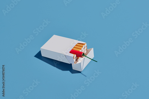 Box with cigarettes and firecracker photo