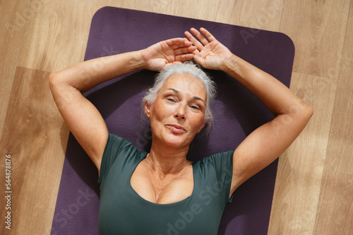 Woman doing fitness exercise on mat photo