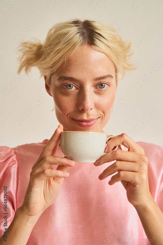Happy blond woman enjoying tea Happy blond woman enjoying tea
