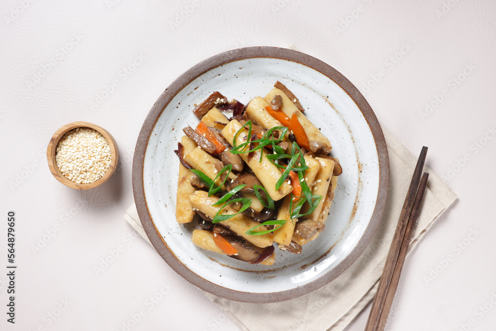Gungjung Tteokbokki or Ddukbokki is Rice Cake, Slices Beef, and Various Vegetables Stir Fry with Soy Sauce. Gungjung Tteokbokki or Ddukbokki is Rice Cake, Slices Beef, and Various Vegetables Stir Fry with Soy Sauce.