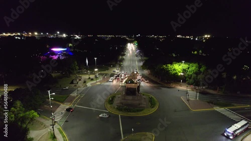 Dolly in aerial view of the street at night with low traffic and the Urquiza Monument and Planetarium unlit, Buenos Aires, Argentina photo