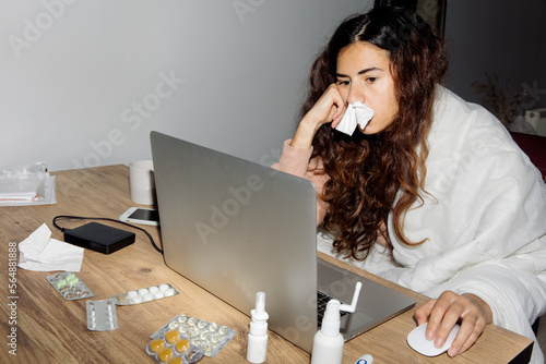 Woman sick and working at home photo