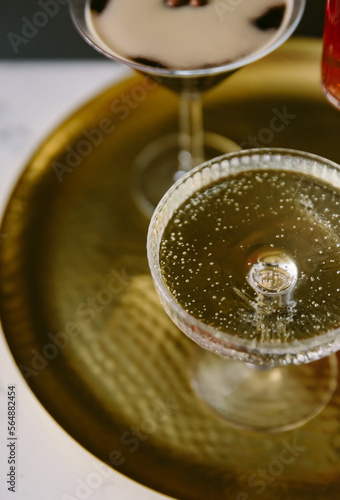 A coupe glass filled with sparkling white wine. photo