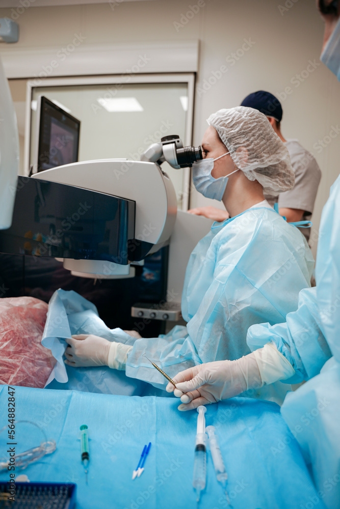 The surgeon performs an eye operation The surgeon performs an eye operation