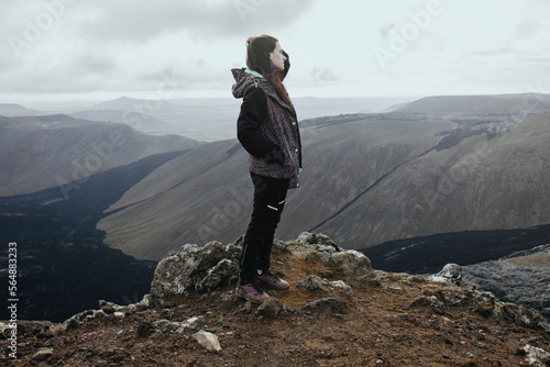 Scenery View Of young Women looking on volcano in Iceland photo