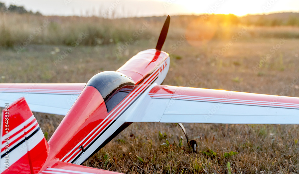 Naklejka premium airplane model on the runway at sunset
